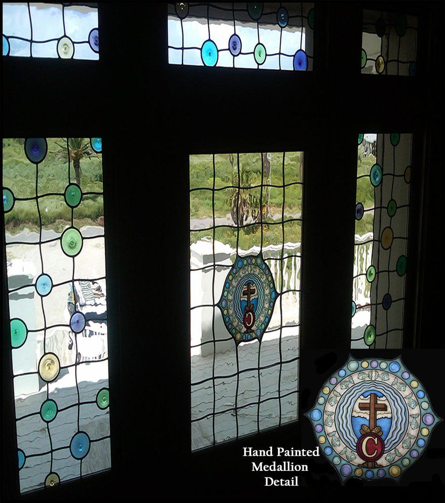 Beach house entry windows in clear leaded glass with jewels and a hand-painted cross medallion, by Monica Huber
